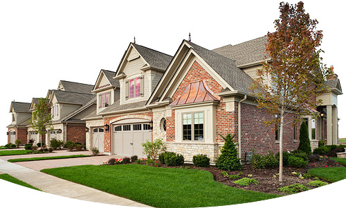 A row of high-end homes with beautifully manicured landscaping